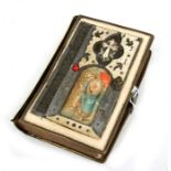 A Bible with Cyrillic text, the boards with bone panels, the front panel decorated with an icon,