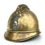 A French brass fireman's helmet with Pompiers crest, 21cms wide.