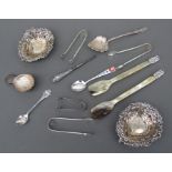 A silver caddy spoons; together with three silver spoons; pierced silver bonbon dishes; silver sugar