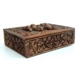 An Indian hardwood table top casket profusely carved, 25cms wide.