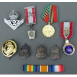 A group of medals, badges and medallions to include three silver ARP badges and two Masonic