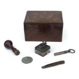 A 19th century figured mahogany box; together with a desk seal with armorial matrix; a travelling