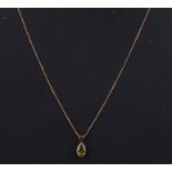 A 9ct gold peridot pendant on a 9ct gold chain; together with a pair of similar earrings (2).