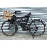 A vintage errand or butcher's bicycle with front carrier with wicker basket, rod brakes, rear stand,