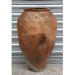 A large terracotta olive jar with banded decoration, 58cms high.Condition Reportwell weathered no