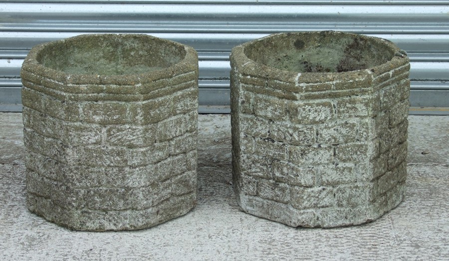 A pair of reconstituted octagonal stone planters, each 35cms wide (2).