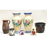A large pair of porcelain vases decorated with flowers on a pale yellow ground, 44cms high; together