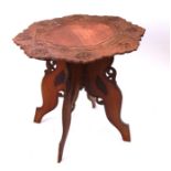 An early 20th century Anglo-Indian carved hardwood occasional table, the circular top profusely