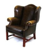 A Georgian style green leather wing back armchair.Condition Report43cm high to the top of the