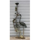 A Japanese style bronzed garden water feature depicting a crane standing beside lilies, 163cms