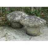 A pair of well weathered concrete low staddle stones