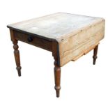 A 19th century pine rectangular kitchen table with single drop flap and two end drawers, on turned