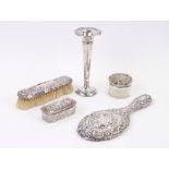 Two silver topped dressing table jars, a silver backed mirror and brush and a silver trumpet vase (