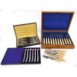 An oak cased canteen of silver plated fish servers; together with a cased set of pistol grip