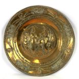 A large brass tray with repousse decoration depicting a Bedouin and maiden, 64cms diameter.