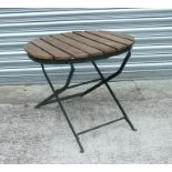 A folding metal garden table with oval slatted wooden top, 60cms wide.