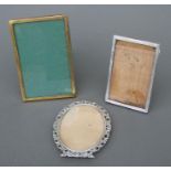 A Dutch silver oval photo frame; together with two English silver photo frames (3).