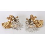 A pair of gilt plaster cherub wall lights with crystal drops, overall 37cms high (2).Condition