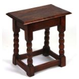 A 17th century style oak joint stool with bobbin turned legs, 44cms wide.