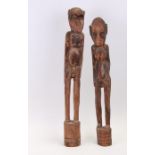A pair of African carved wooden figures of a standing male and female, the largest 70cms high (2).