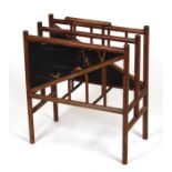 A Japanese hardwood two-division magazine rack with lacquer panels depicting landscape scenes, 39cms