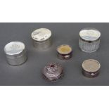 A Mappin & Webb silver pill box, Birmingham 1905; together with four other pill boxes and a silver
