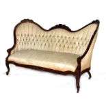 A Victorian walnut show wood camel back sofa with upholstered seat and buttoned back, 155cms (61ins)