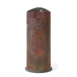 A WWI trench art artillery shell with engraved decoration depicting a German helmet, 20cms high.