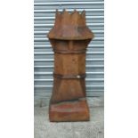 A large Victorian salt glazed earthenware castle top chimney pot, approx 95cms high.