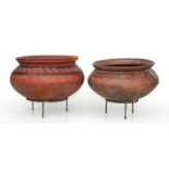A large terracotta pot with slip decoration and stand, 30cms diameter; together with another