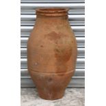 A large terracotta olive jar with zigzag banded decoration, 59cms high.