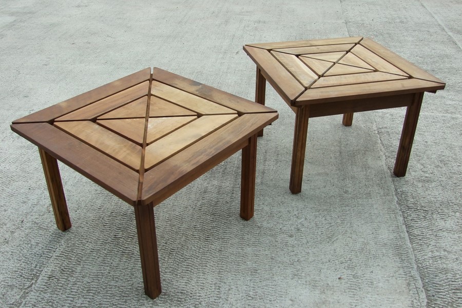 A pair of teak garden tables of rectangular form, on square legs, 70cms wide (2).