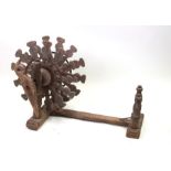 An African carved wooden wool winder, 50cms wide.