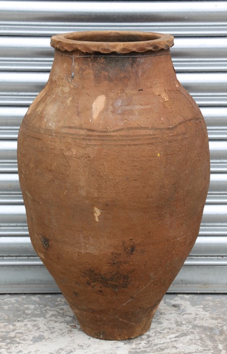 A large terracotta olive jar with banded decoration, 60cms high.Condition Reportwell weathered no