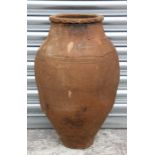A large terracotta olive jar with banded decoration, 60cms high.Condition Reportwell weathered no