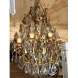 A gilt metal and crystal drop ceiling light, approx 75cms high.