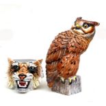 An Italian pottery figure of a long eared owl seated on a tree stump, 50cms high; together with a