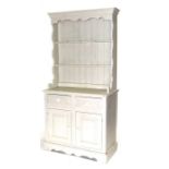 A painted pine dresser with plate rack with two shelves above a cupboard with two frieze drawers and