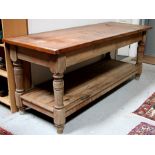 A large two-tier pitch pine serving table on turned supports, 217cms wide.Condition Reportno signs