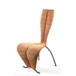 A contemporary seagrass S-Chair in the manner of Tom Dixon with steel structure covered woven