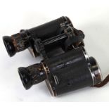 A pair of German military Carl Zeiss Jena Dienstglas 6x30 binoculars with correct eye piece cover.