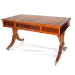 A bespoke yew wood Regency style writing table, the rectangular top with inset leather top above