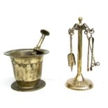 A brass pestle & mortar, 12cms diameter; together with a brass four-piece miniature fire iron set on