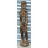 A large African carved wooden figure in the form of a standing man, approx 118cms high.