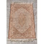 A small Persian prayer mat decorated with foliate scrolls on a beige ground, 69 by 105cms.