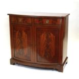 A George III style bowfront side cabinet with two frieze drawers above a pair of panelled doors,