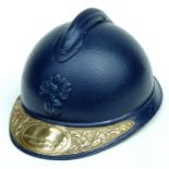 A repainted blue WW1 French Adrian helmet with brass plaque to show that the wearer served in the
