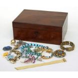 A mahogany box containing assorted costume jewellery to include necklaces and bracelets.