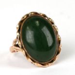 A 14ct gold ring set with an oval jade cabochon, total weight 5g, approx UK size 'N'.