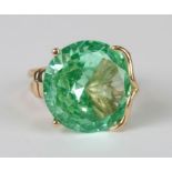 A 14ct gold cocktail ring set with a large pale green stone, total weight 9.4g, approx UK size 'N'.